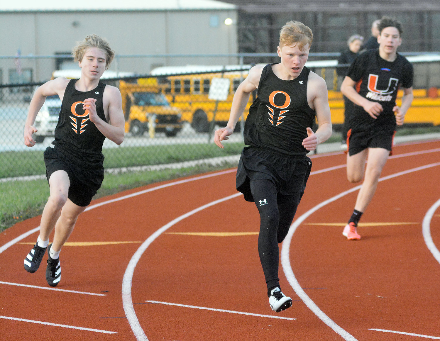 Connor Wellman and Cody Lenauer (from left) look to stay ahead of Union’s Hunter Pruitt during the boys 200-meter dash